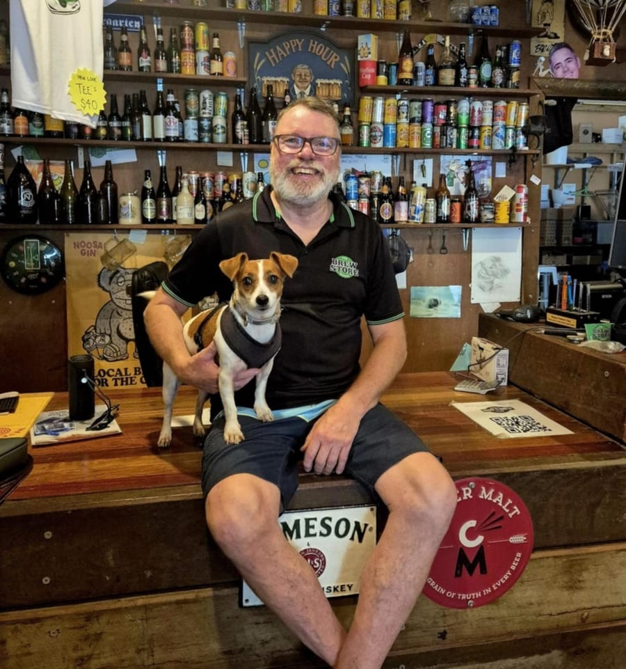 Marty Howell, owner of The Brew Store Noosa, with his dog at the shop counter